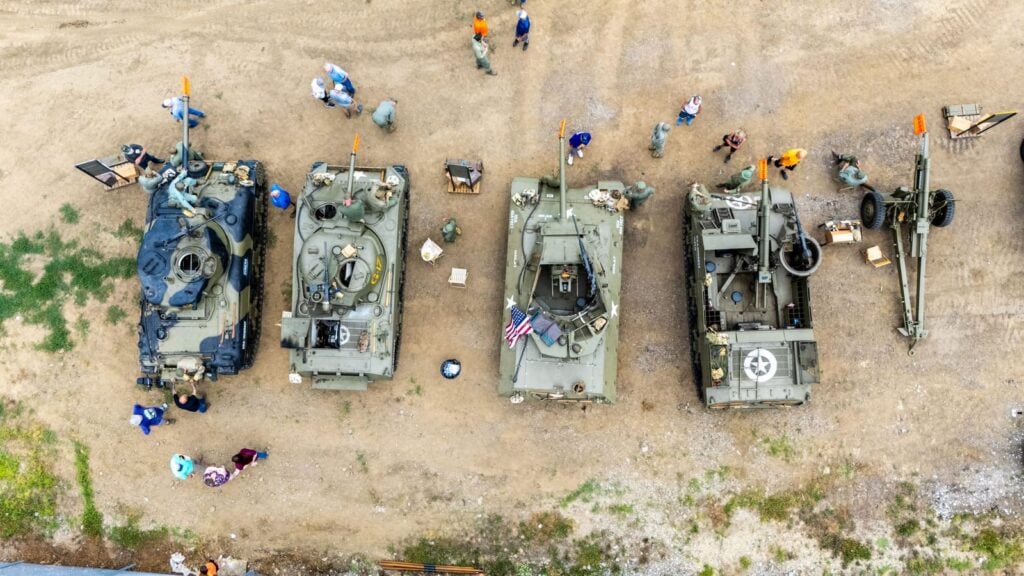 Top-down drone photo of three military tanks at the 2025 Morgan County Fair
