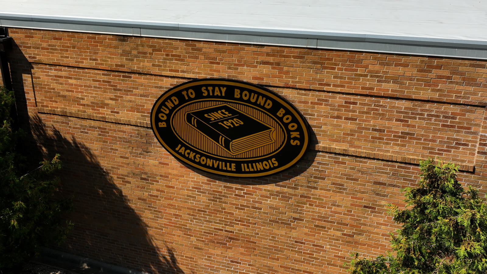 Bound To Stay Bound Books sign on the brick facility in Jacksonville IL - aerial drone photo