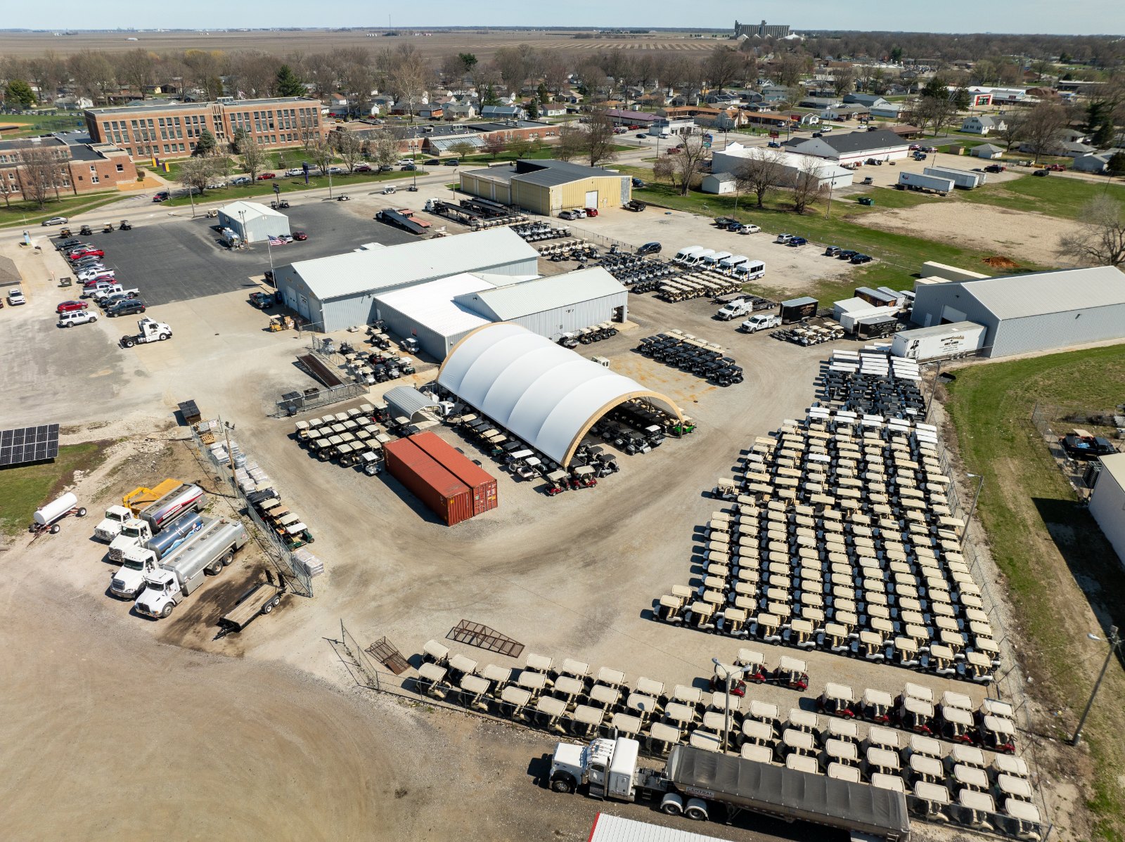 Aerial drone photo of hundreds of golf carts in inventory at Battery Specialists + Golf Cars in Taylorville IL