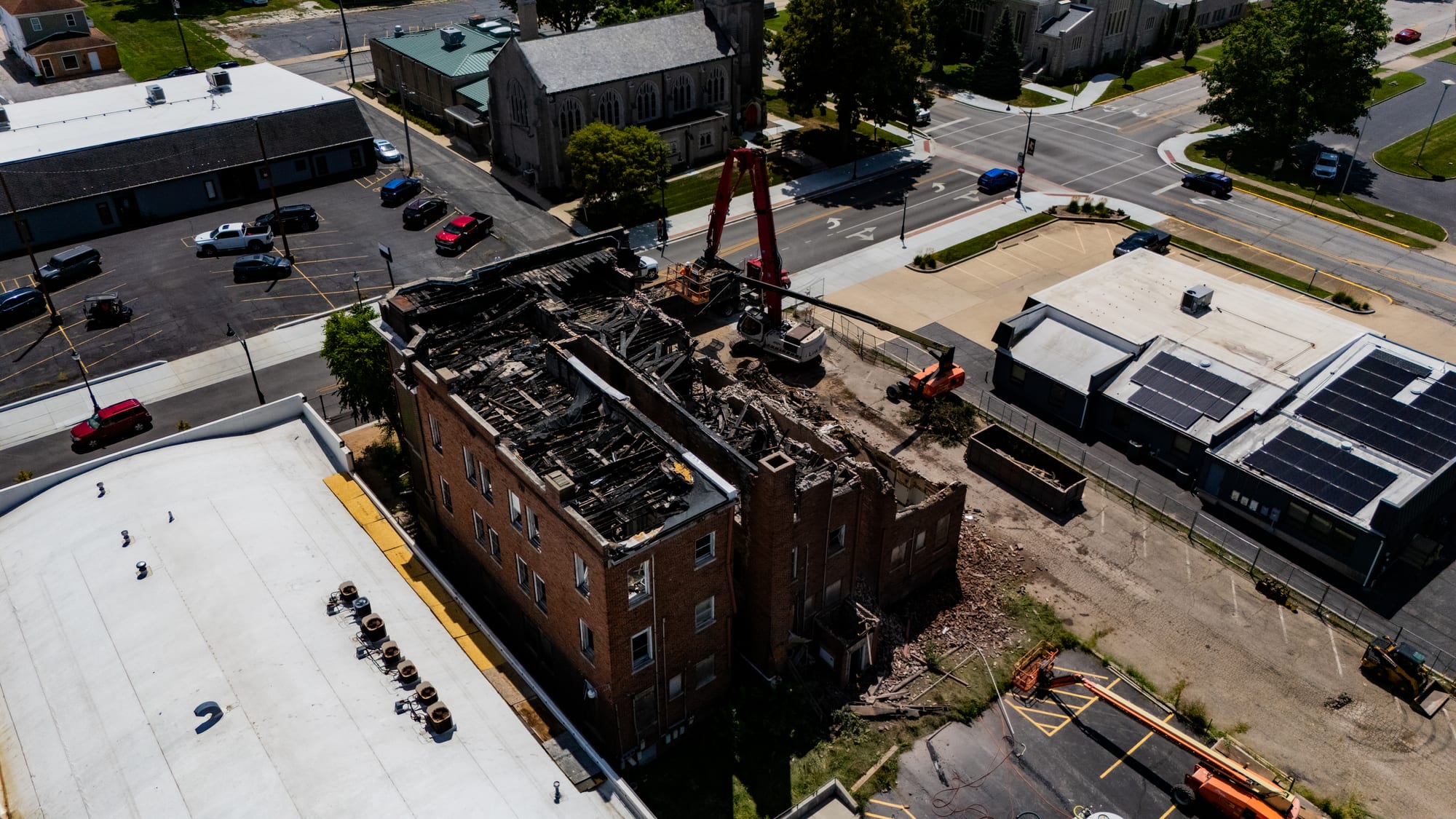 Overhead drone photo of the burned-out top floor of the Cherry Apartments, Jacksonville IL, showing collapsed roof framing from the January 2026 fire