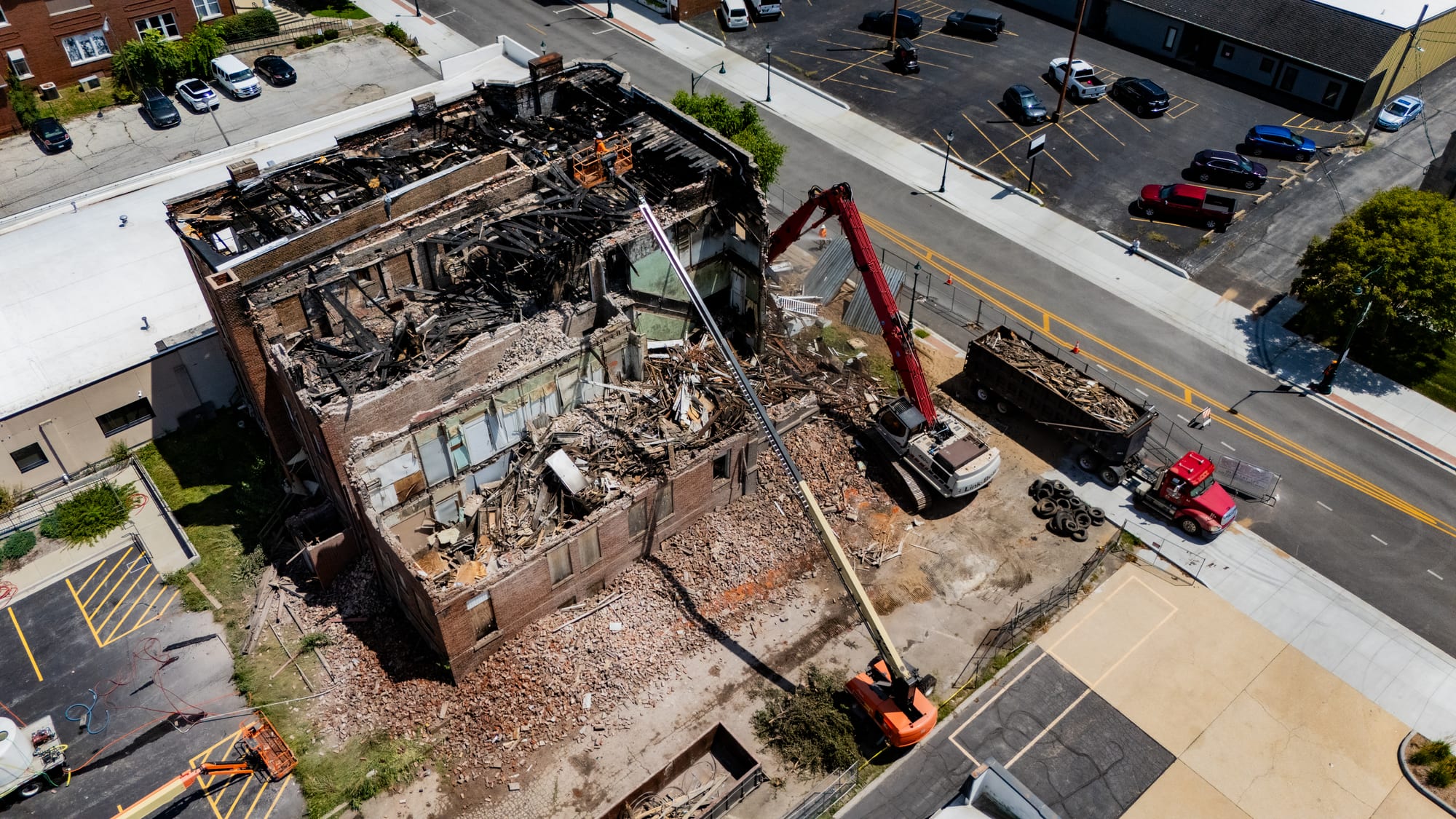 Aerial drone photo of the Link-Belt high-reach excavator pulling down the west wall of the Cherry Apartments, Jacksonville IL