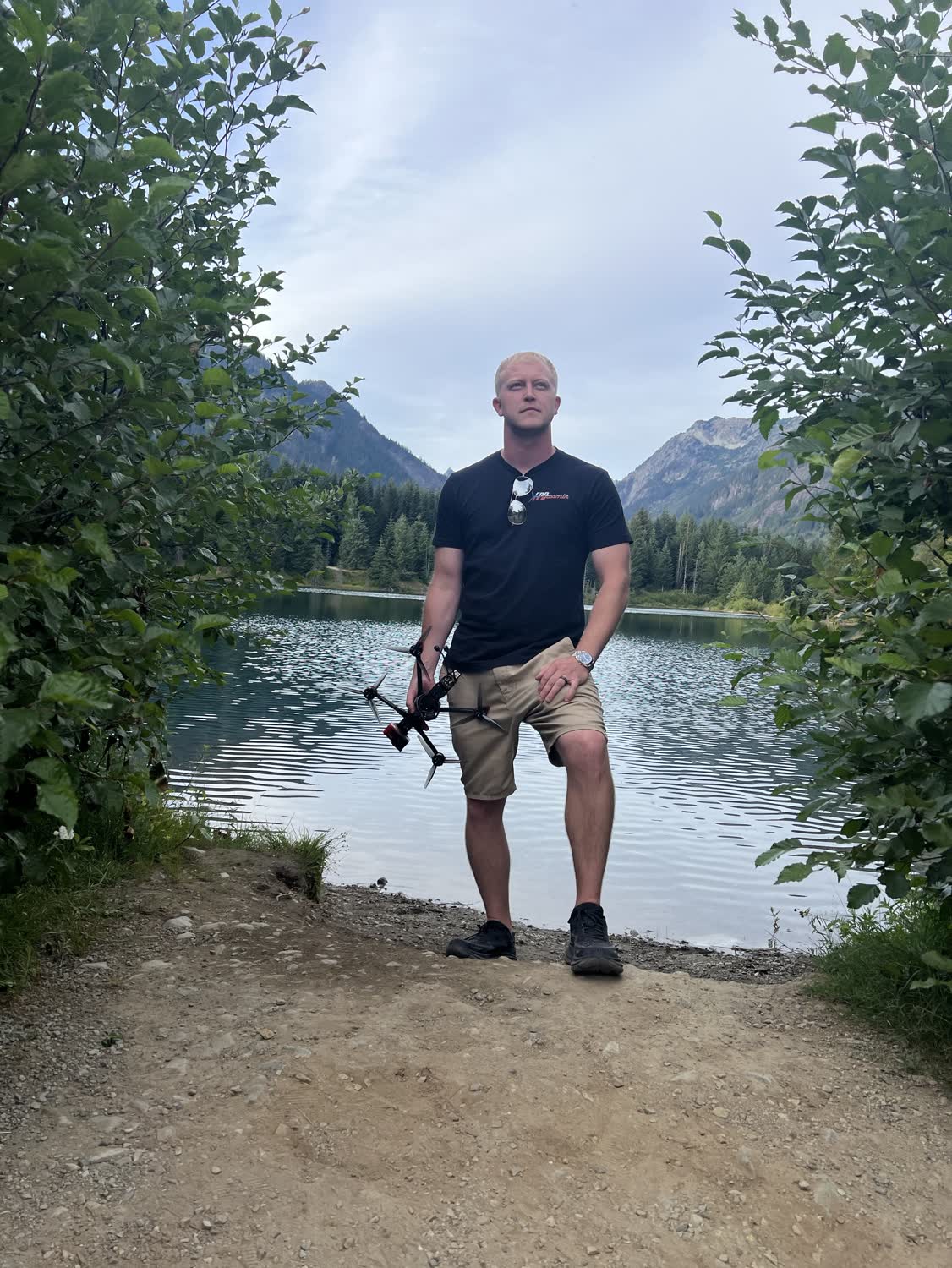 Ryan Mason of Elevated Ideas holding an FPV drone on the shoreline of Gold Creek Pond, Washington