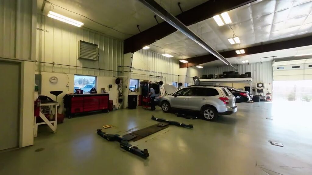 FPV drone flying through Floyd Imports auto shop and used car lot in Springfield, Illinois