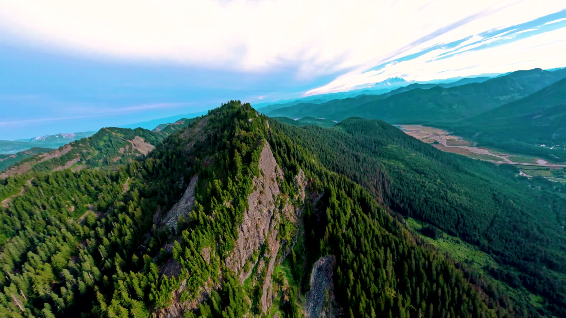 Drone view of a forested ridgeline above Gold Creek Pond at Snoqualmie Pass, Washington