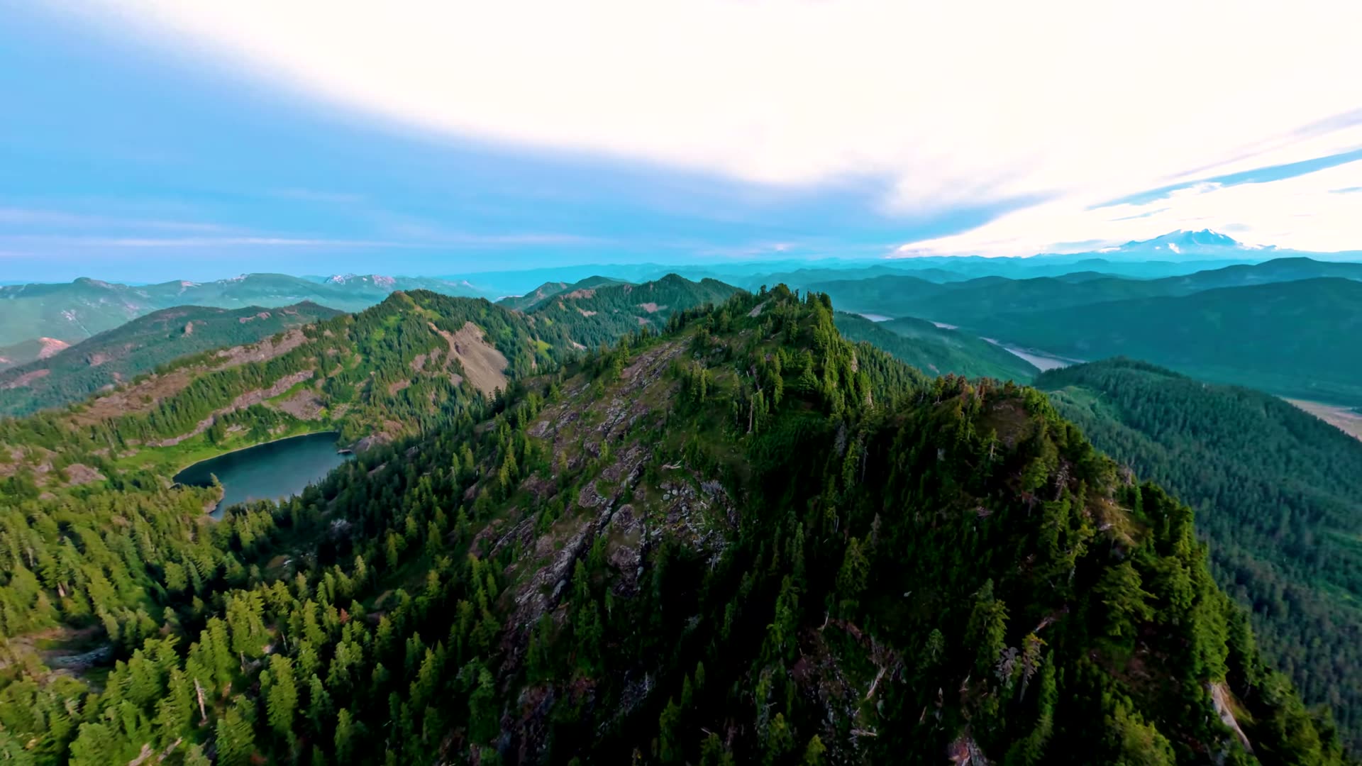 Cascade Mountains ridgeline above Gold Creek Pond seen from a drone in summer