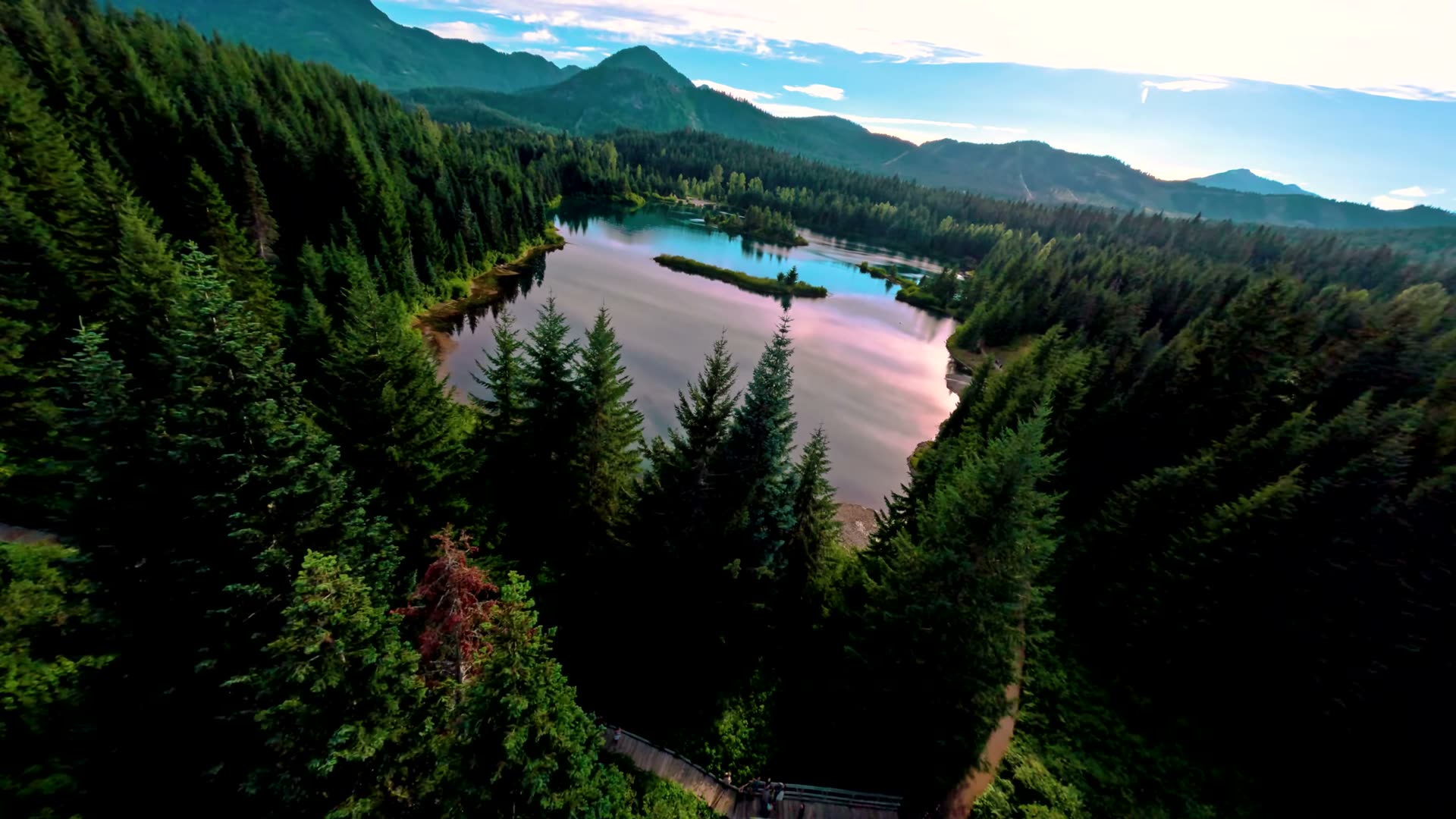 Sunlight reflecting off the still surface of Gold Creek Pond in an aerial photo