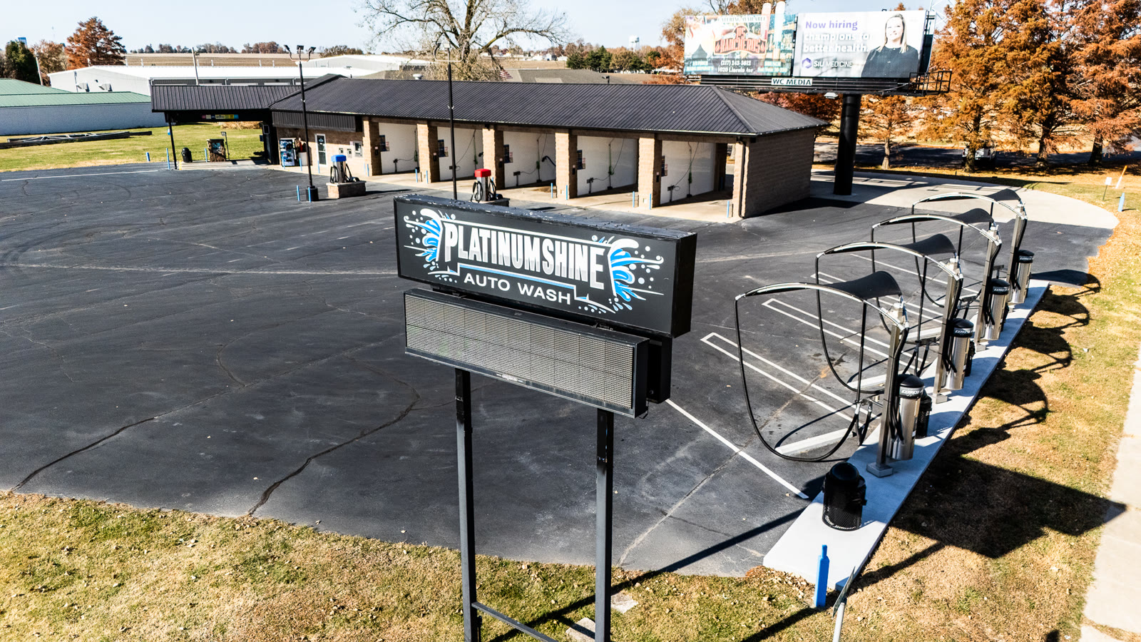 Platinum Shine Auto Wash sign and self-serve vacuum stations in Jacksonville IL - drone photo