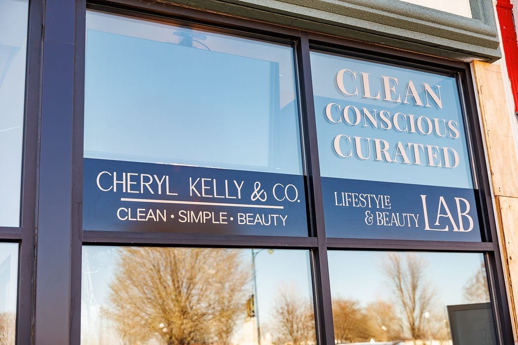Cheryl Kelly & Co. storefront window in downtown Jacksonville IL reading Clean Conscious Curated and Lifestyle & Beauty LAB