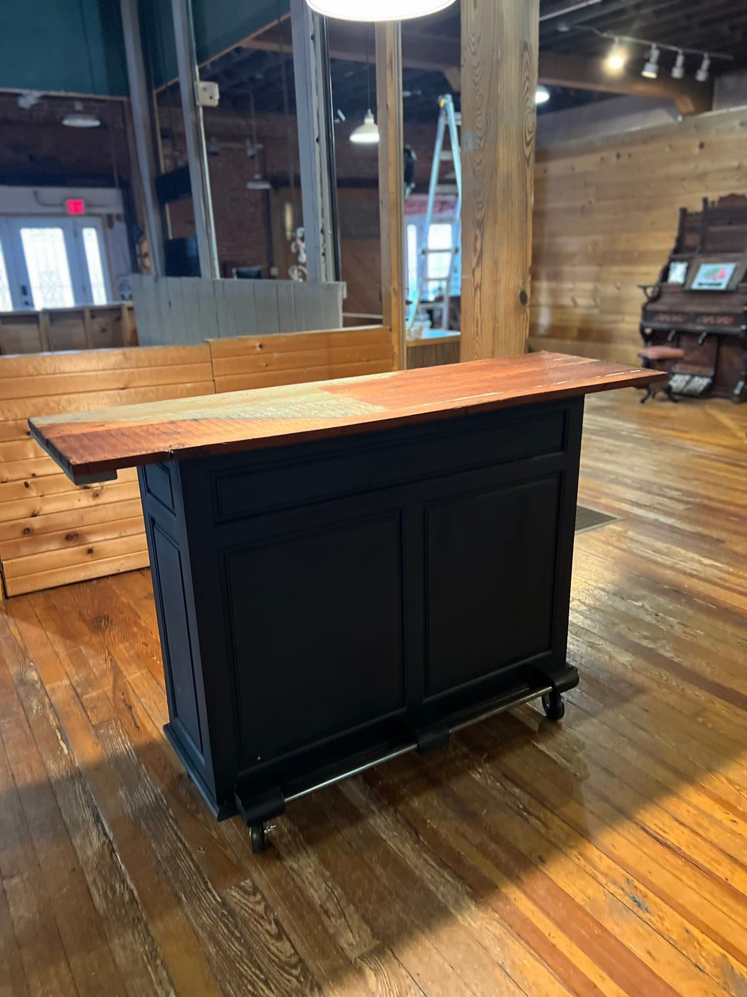 Custom black kitchen island on casters with a reclaimed wood top, built by Jacksonville Transfer Company in Jacksonville, Illinois