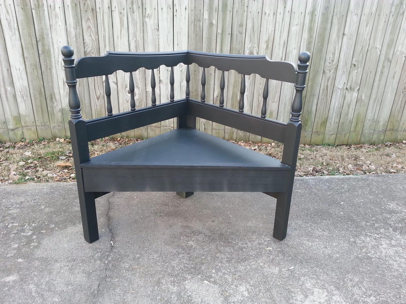 Black painted corner bench with reclaimed wood spindle back, custom built by Jacksonville Transfer Company in Jacksonville, Illinois