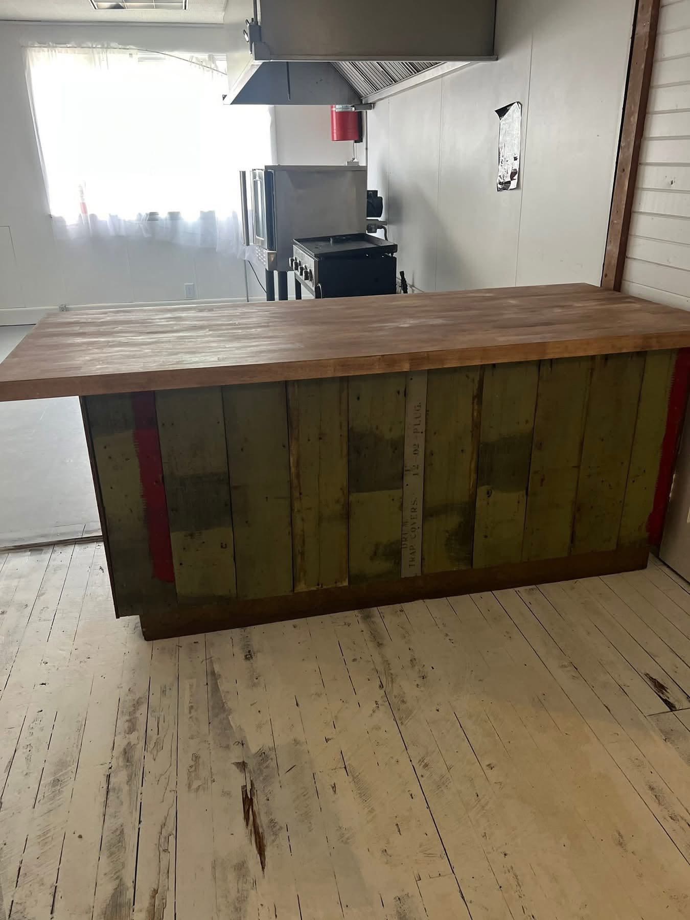 Custom island cabinet faced with reclaimed wood boards, built by Jacksonville Transfer Company in Jacksonville, Illinois